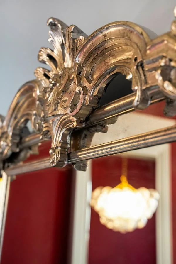 A gilded mirror and a lantern