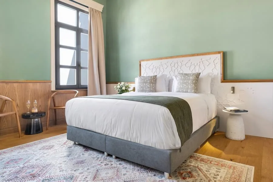A bed on a patterned rug