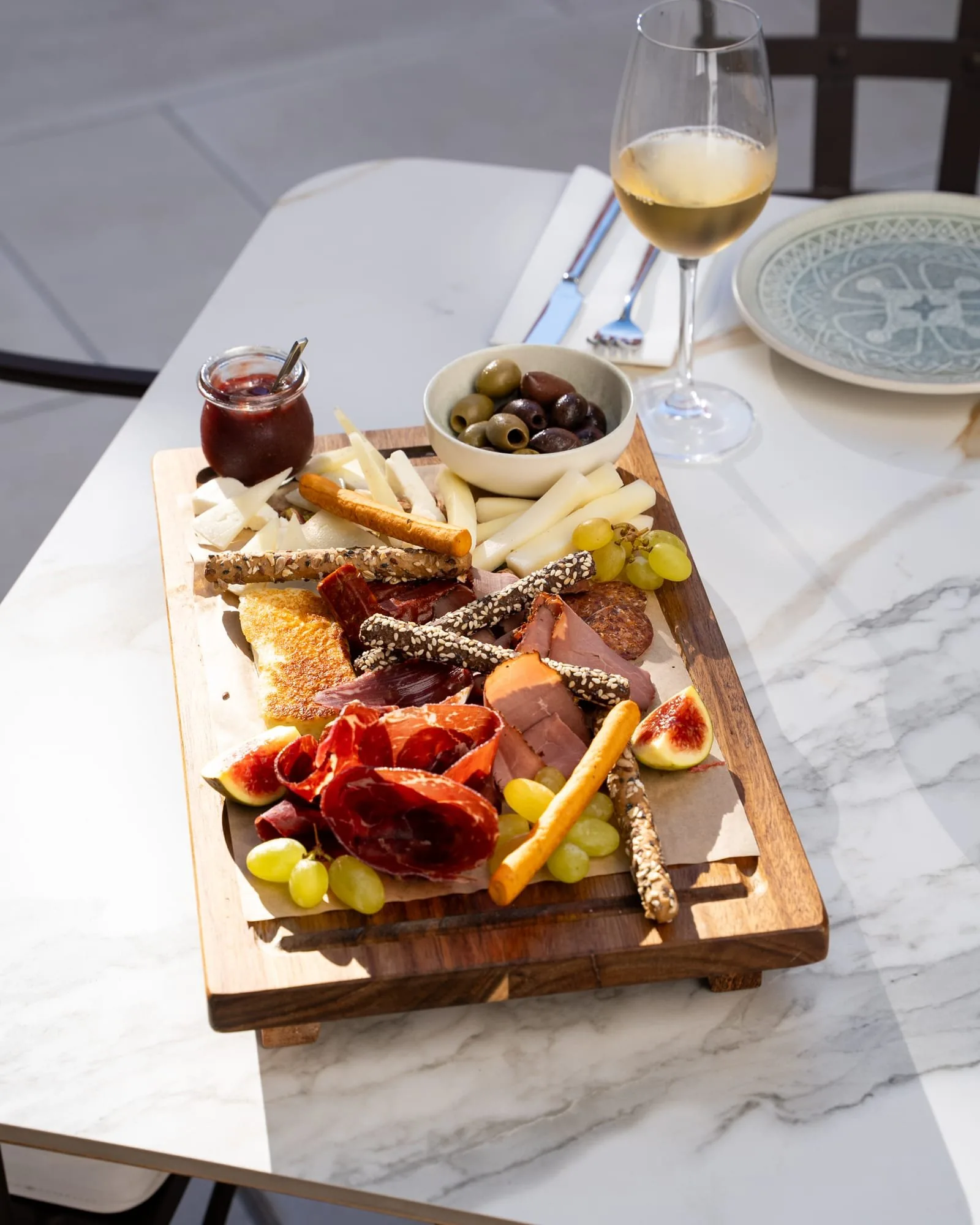 A charcuterie board and wine in the courtyard